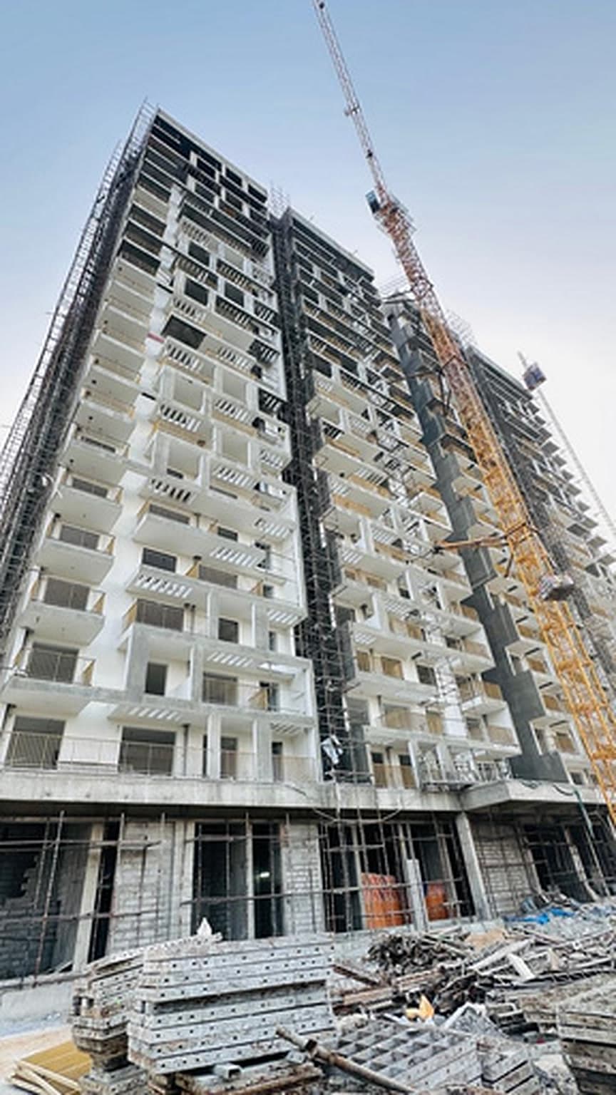 GITAM Residency apartment tower under construction with scaffolding and a tower crane