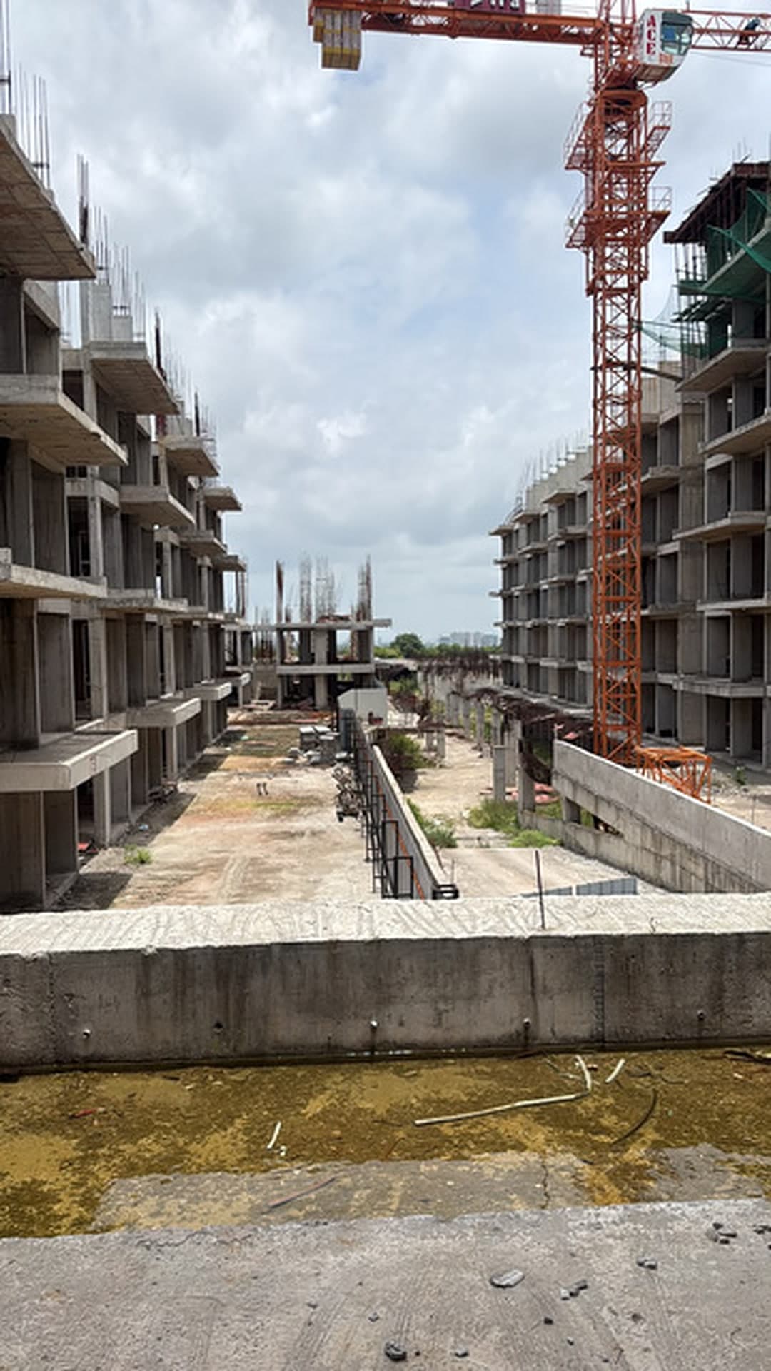 Multi-block structure under construction with a tower crane at Heyday senior living community