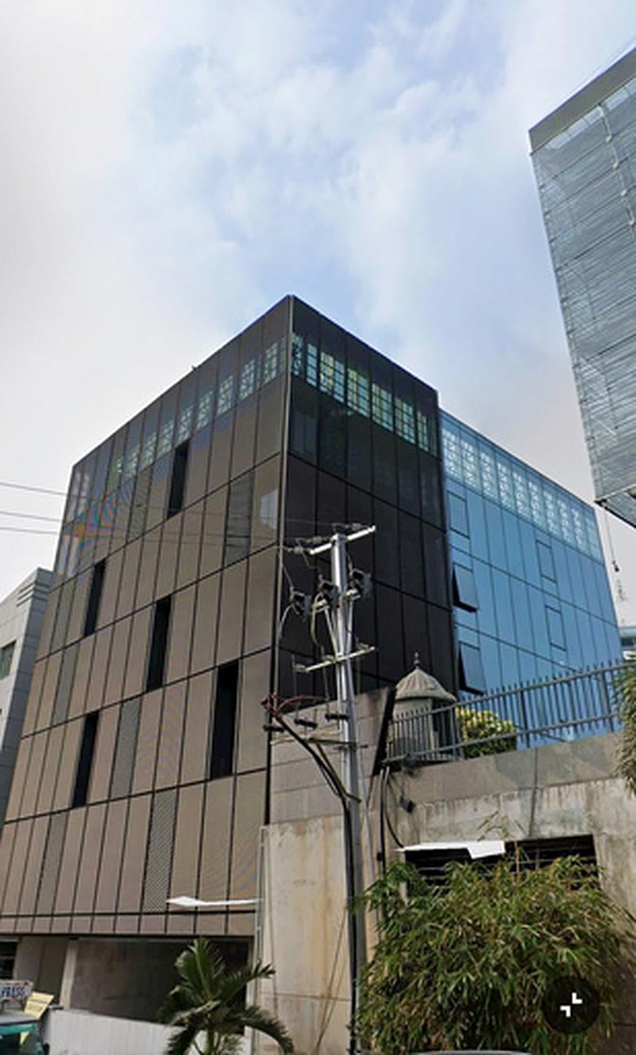 Completed Jayabheri NEXA commercial building with a dark glazed facade in Kondapur